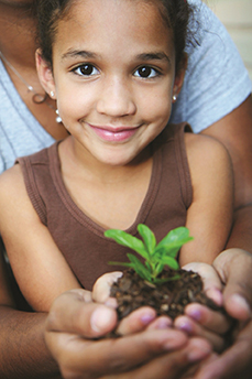 decorative photo of child holding plant