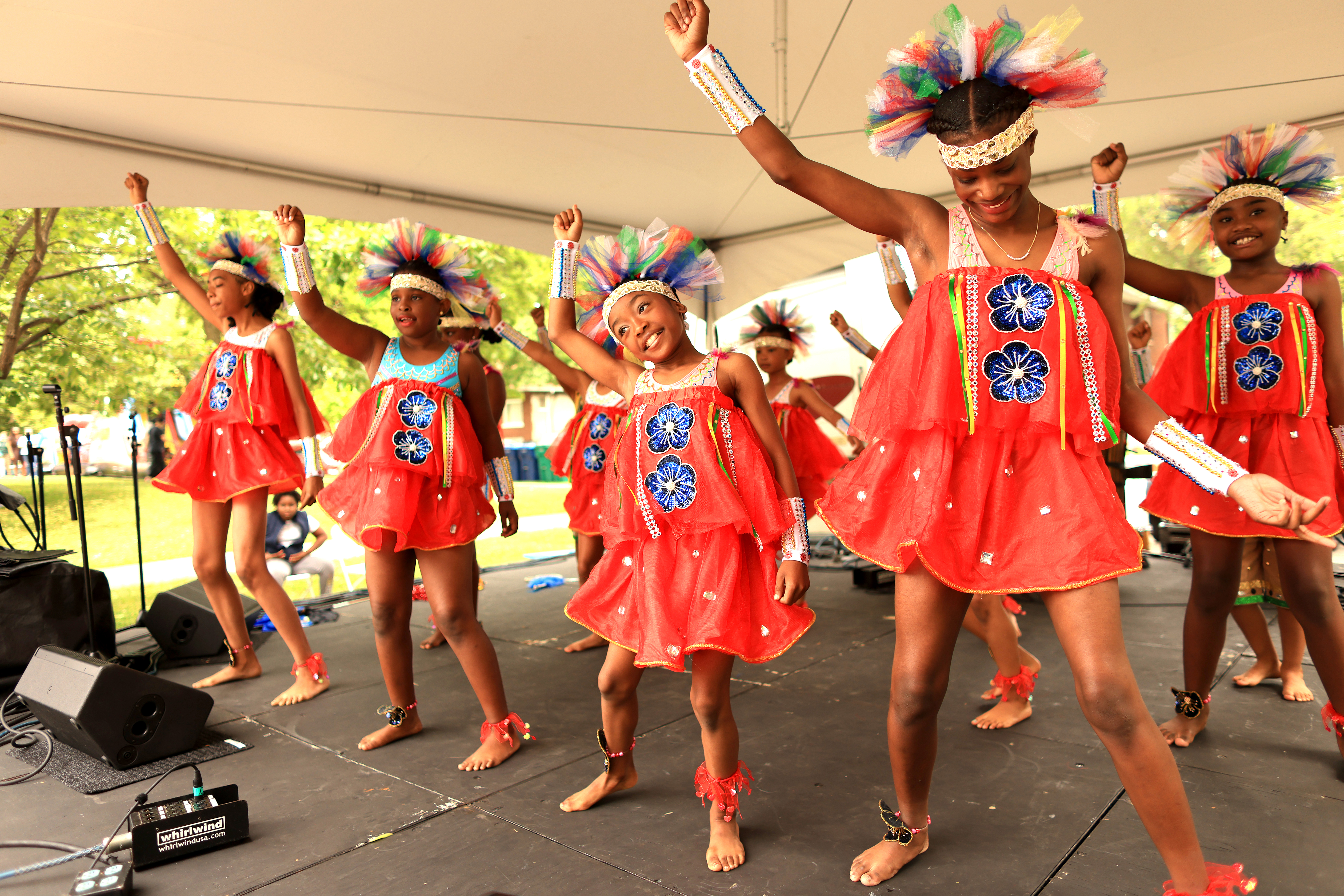 Dancers dressed in red perform on a stage