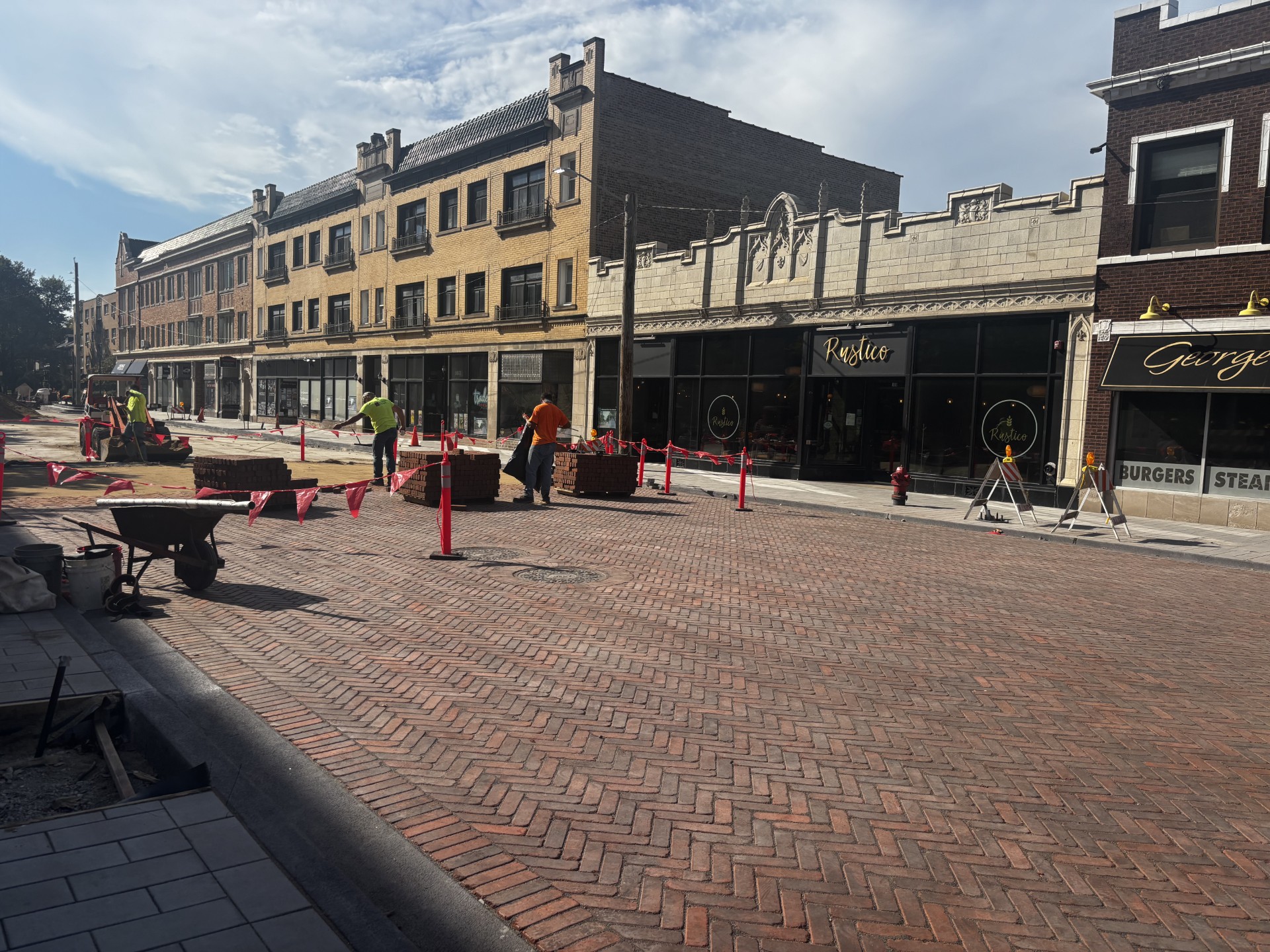 Construction crews lay brick in the roadway on Oak Park Avenue