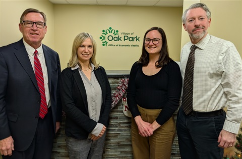 John Melaniphy, Cindy Hansen, Nicole Nodi and Michael Mertes stand in front of an Oak Park Office of Economic Vitality sign