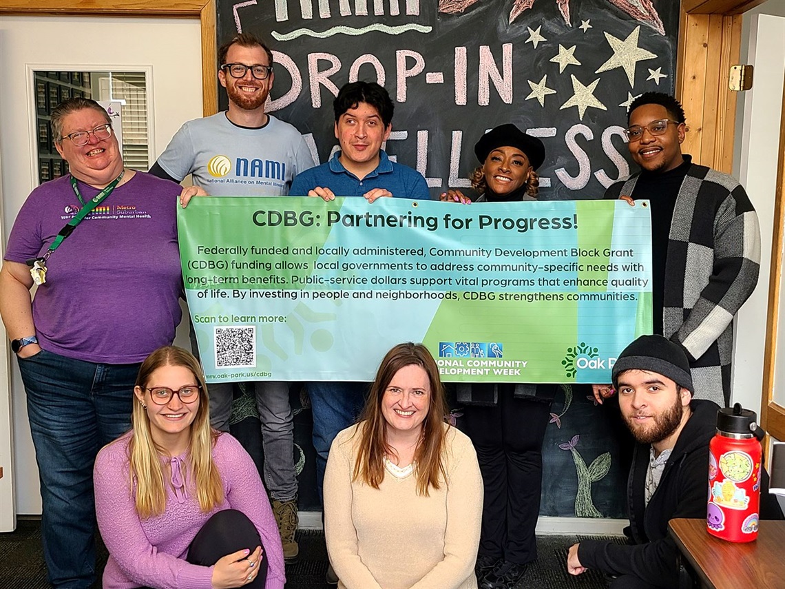 NAMI staff celebrate CDBG week with banner.
