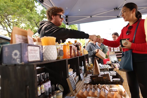 Vendor and customer interact at Oak Park Farmers' Market