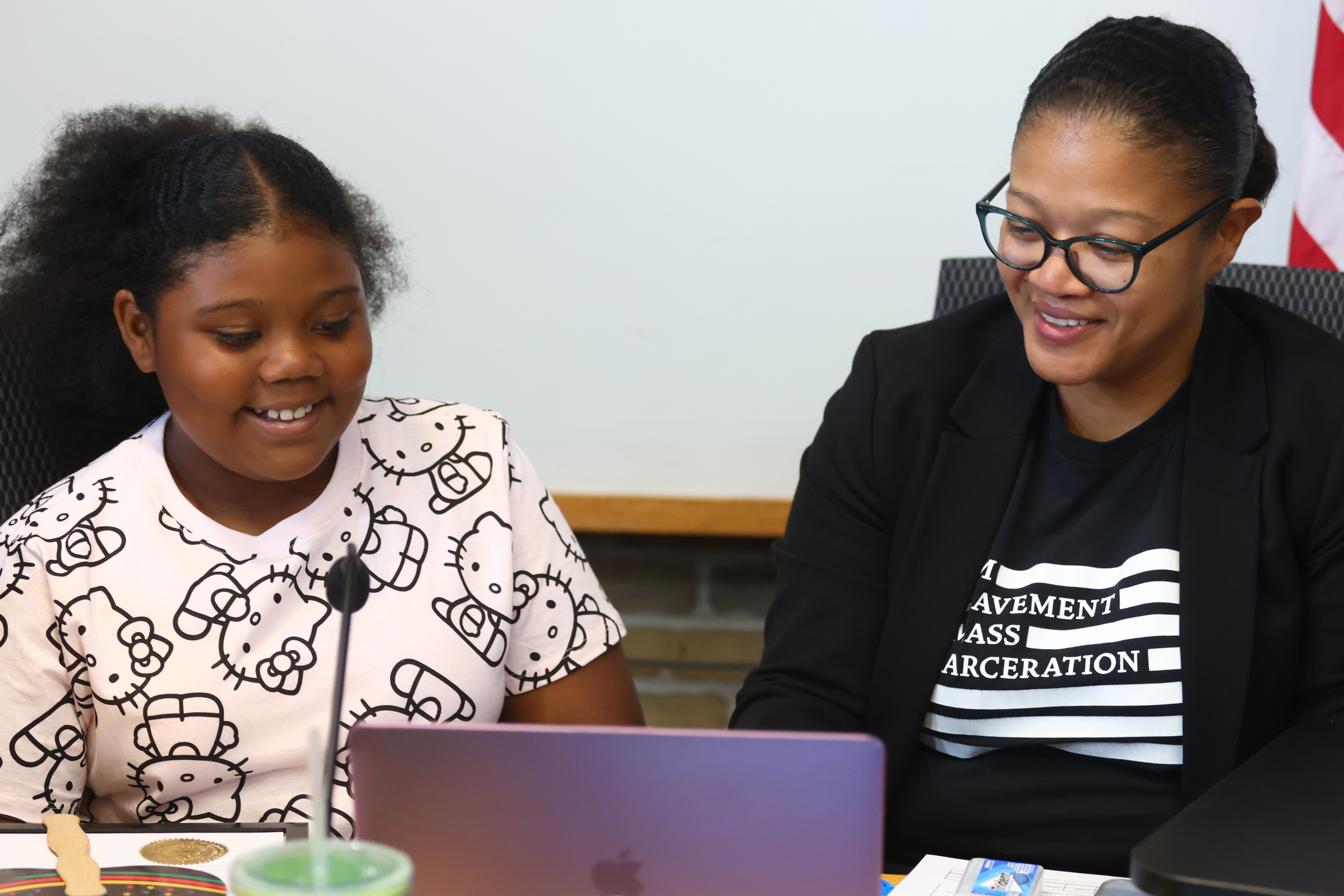 Junior Deputy Clerk looks at a computer screen with Village Clerk Christina M. Waters