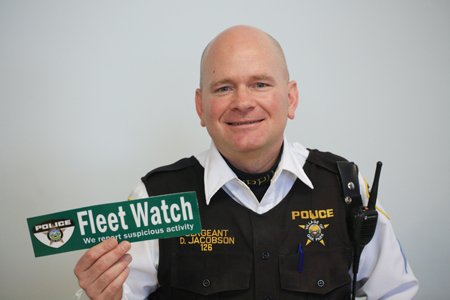 Police Sergeant Dave Jacobs with the Fleet Watch decal on Village Vehicles