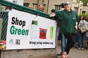 Photo of Sustainability Manager Mindy Agnew with recycling banner at the Farmer's Market